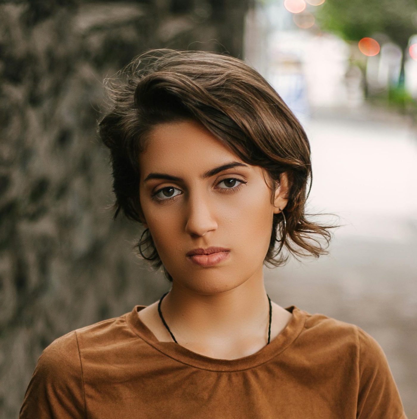 Portrait of a fashionable young woman standing outdoors in São Paulo, Brazil.